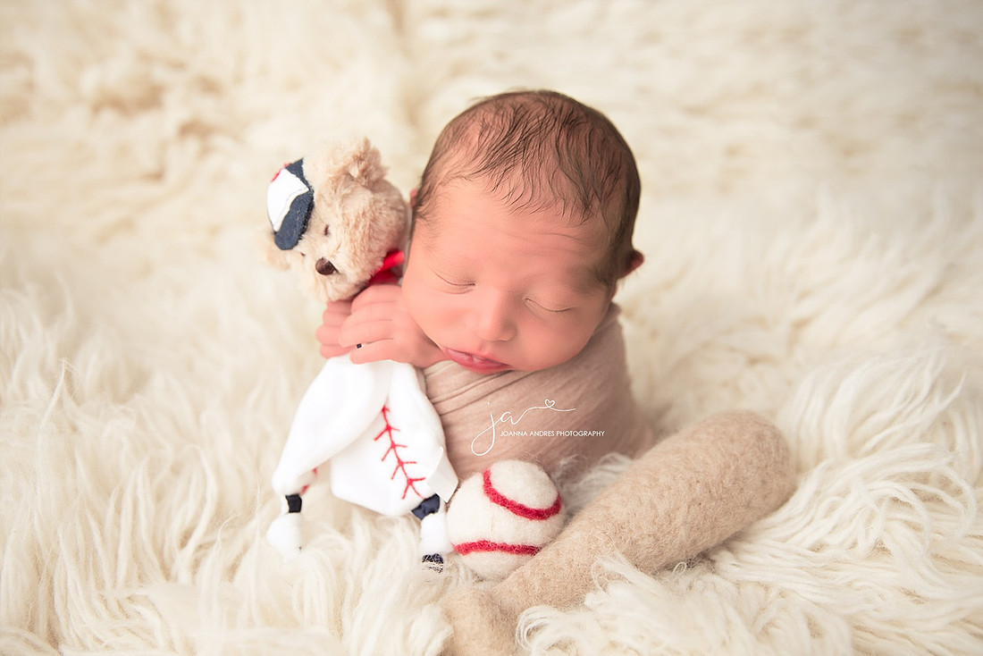 Baby Boy holding teddy lovey with baseball