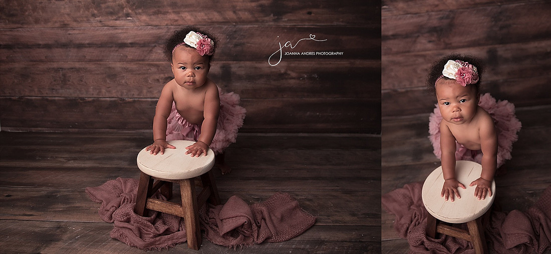 Baby Girl leaning on a stool with pink tutu and headband