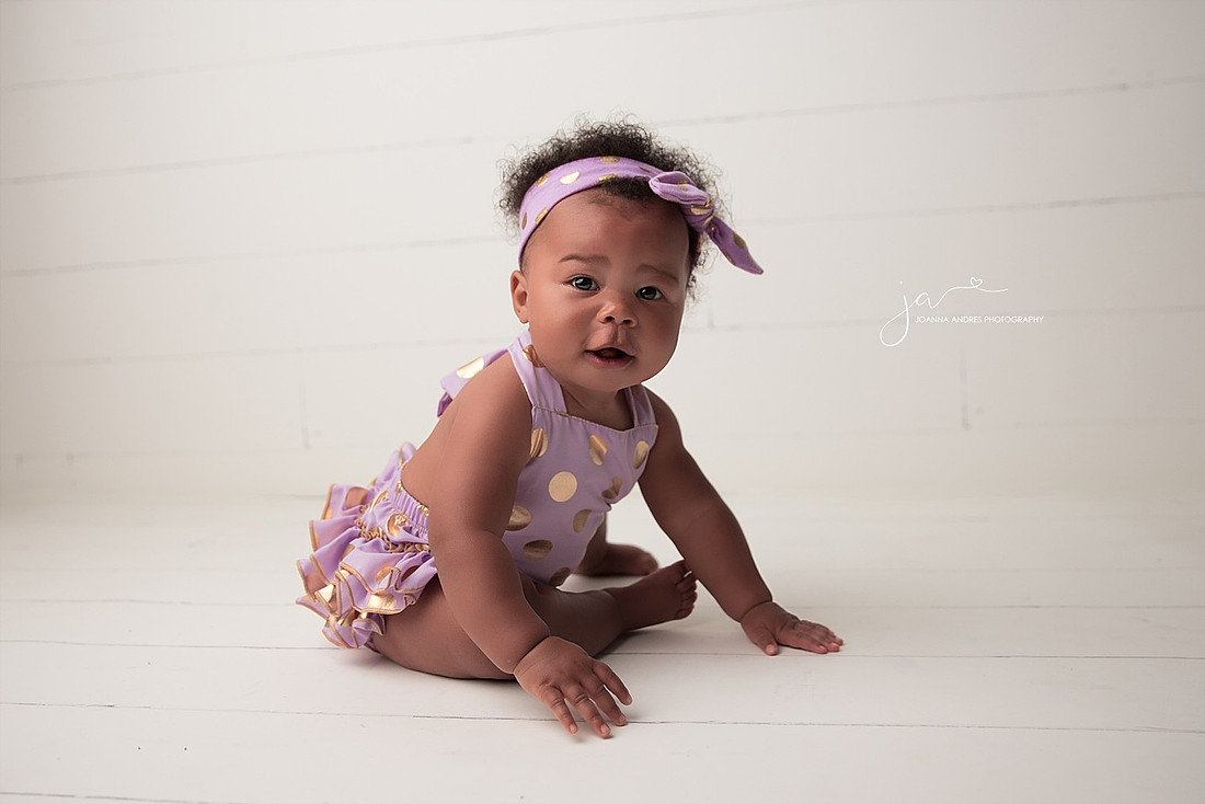 Baby Girl sitting with white backdrop