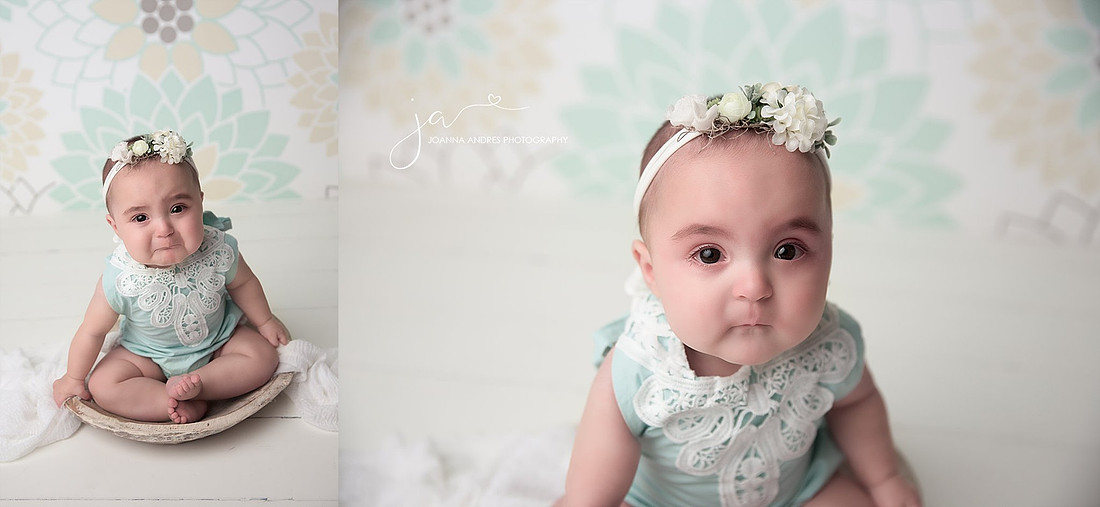 Baby Girl in mint romper with pouty face