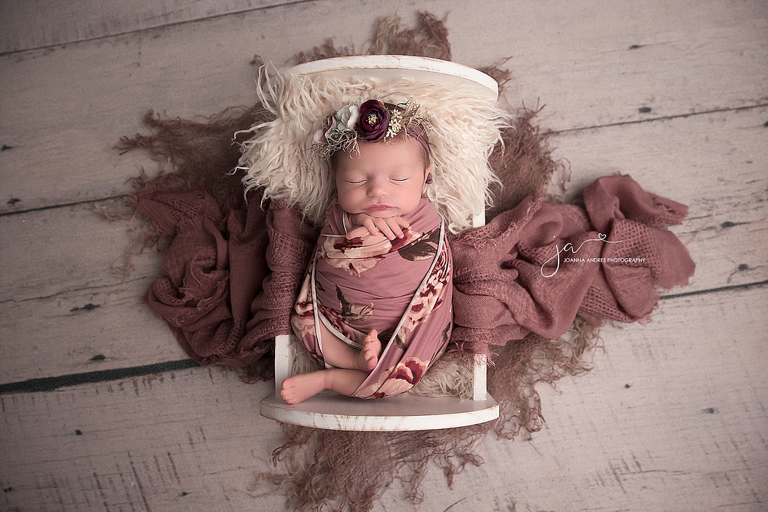 Baby in Bed wrapped in floral wrap