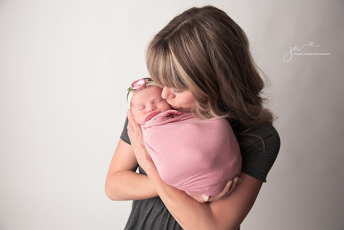 Mom Kissing Baby Girl