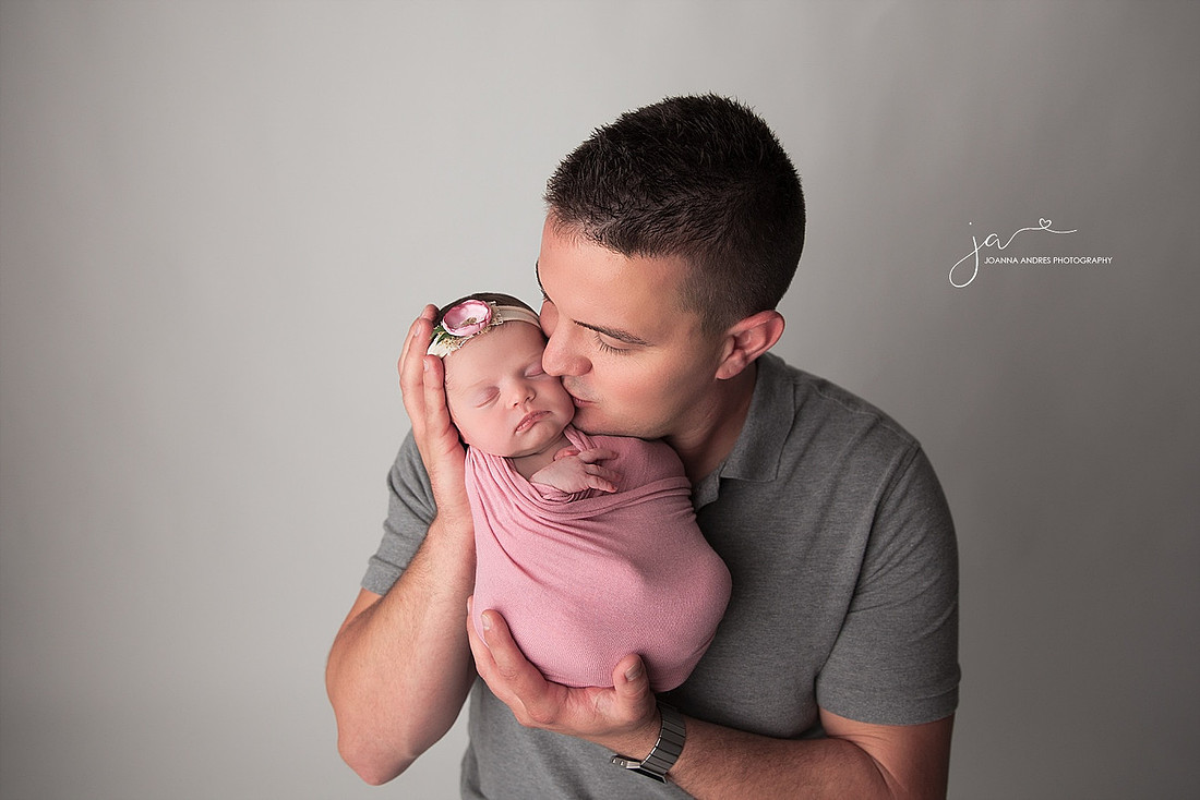 Dad kissing baby girl
