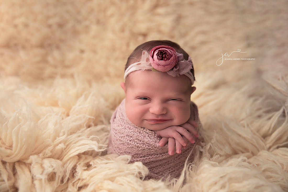 Baby wrapped up and smiling