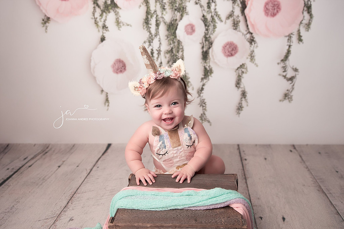 Happy Baby in a unicorn outfit