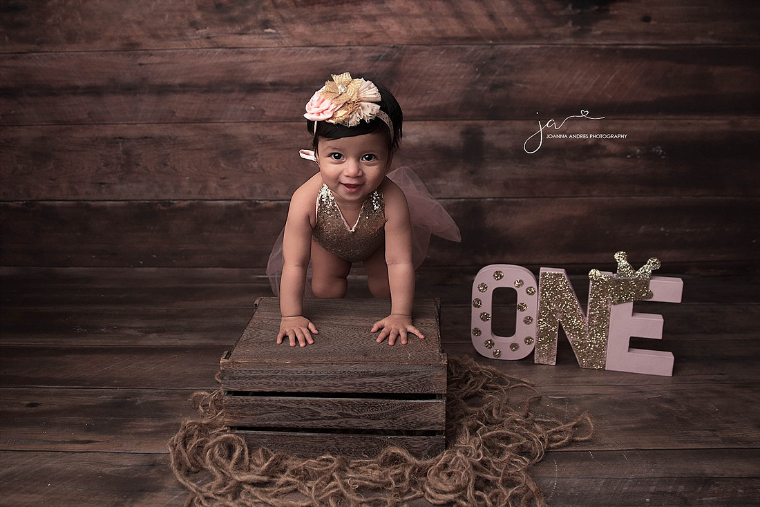 Baby leaning on stool