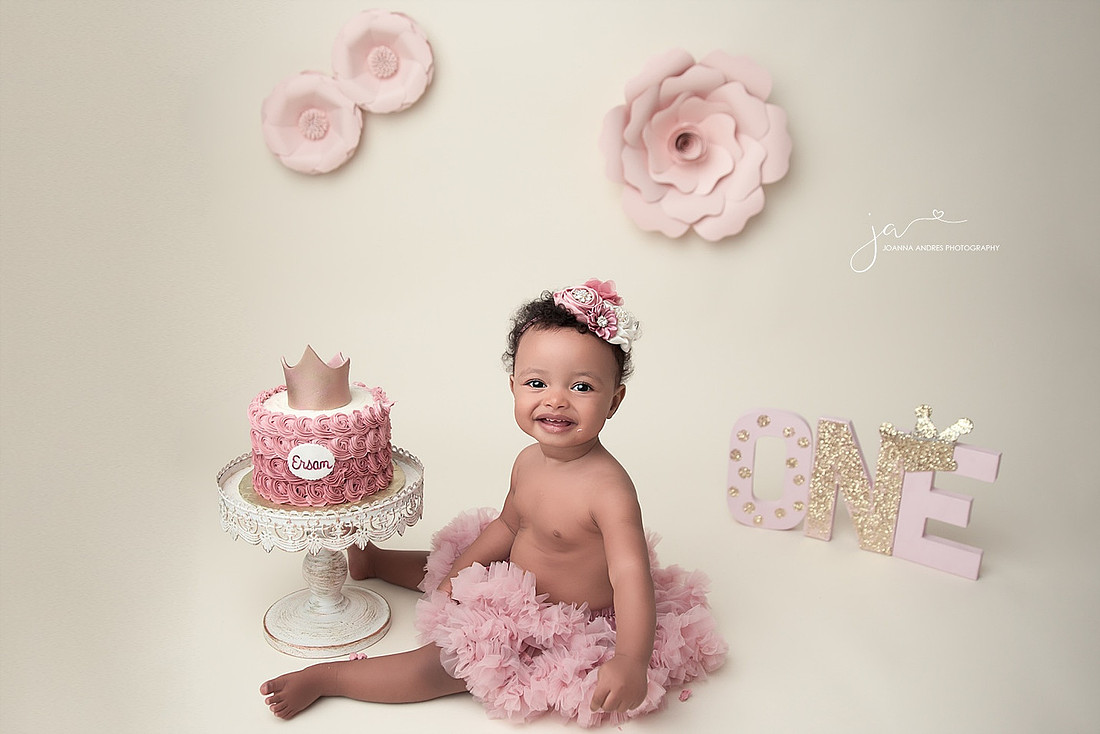 Baby Girl One Year Birthday with cake and flowers
