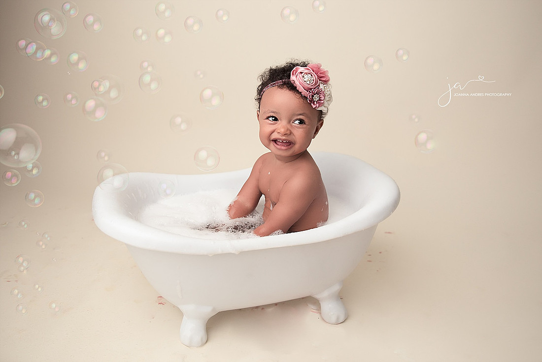 Baby Girl in a bathtub with Bubbles.