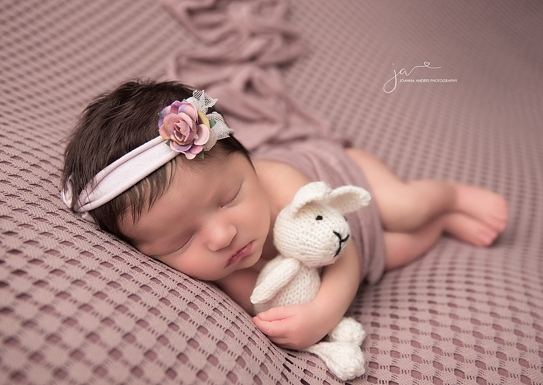 Side laying pose with Baby Bunny Lovey on a mauve backdrop