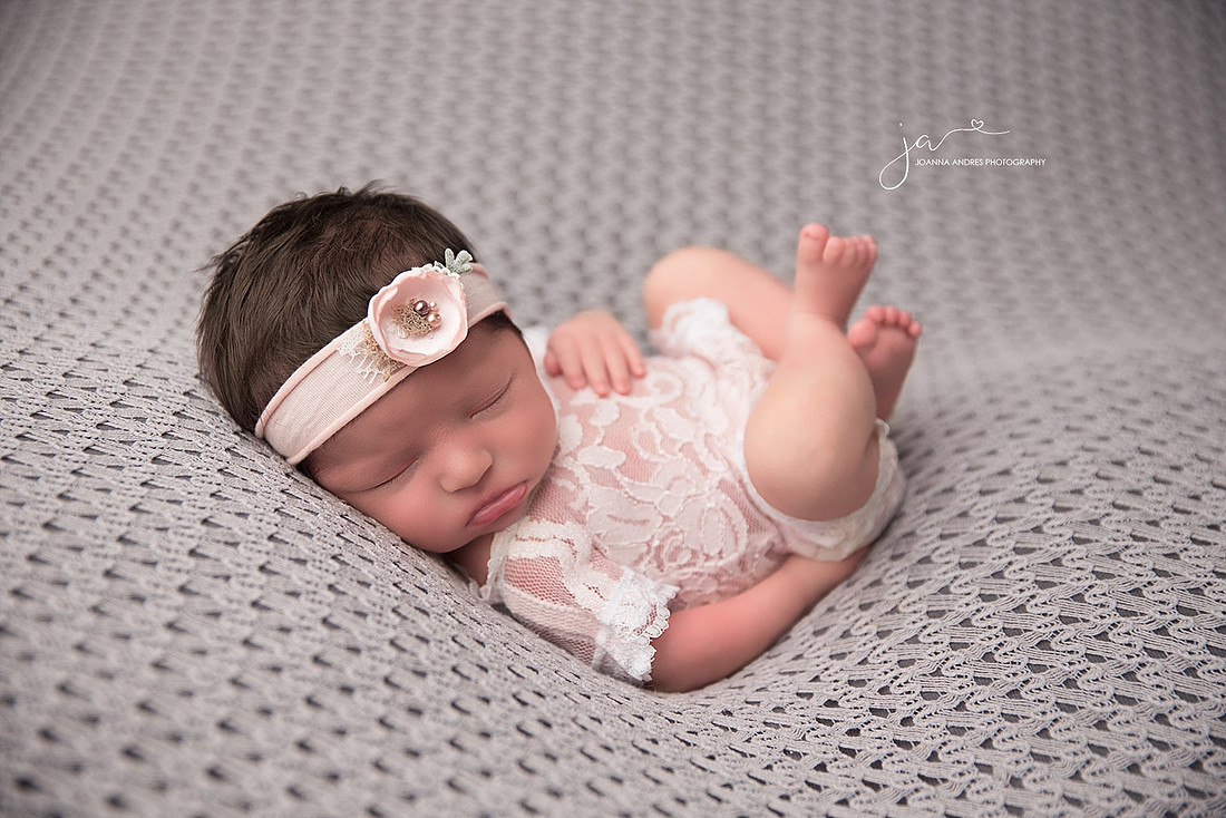 HUck Finn Pose of Baby in Lace with Gray Backdrop