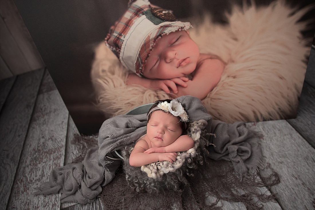 Baby in bucke with photo of her big brother behind her