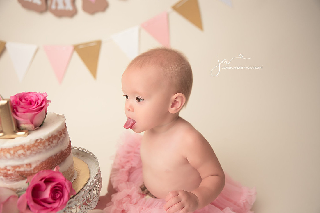 Baby Sticking tonque out at cake