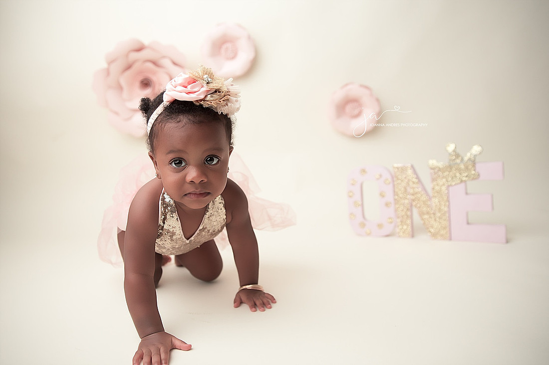 Baby girl crawling toward the camera