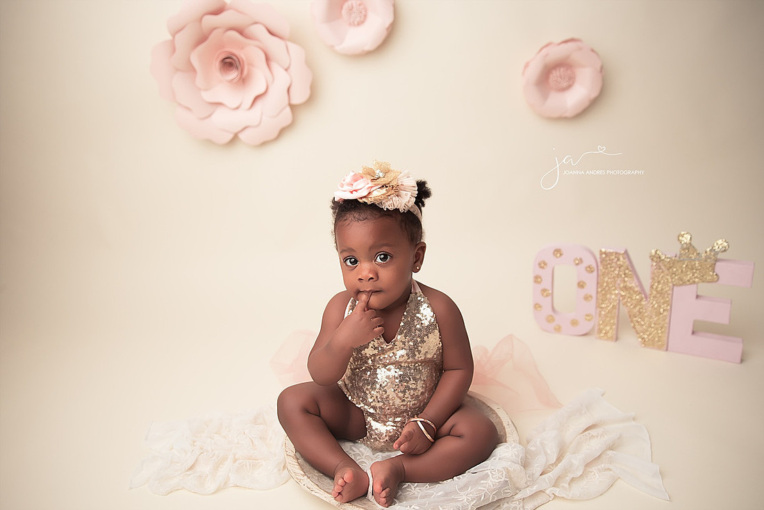 Baby girl in gold sequence and pink tulle for her 1st Birthday