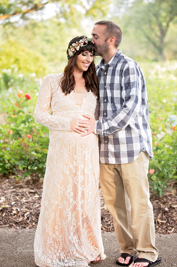 Maternity Session with couple husband kissing wife on forehead