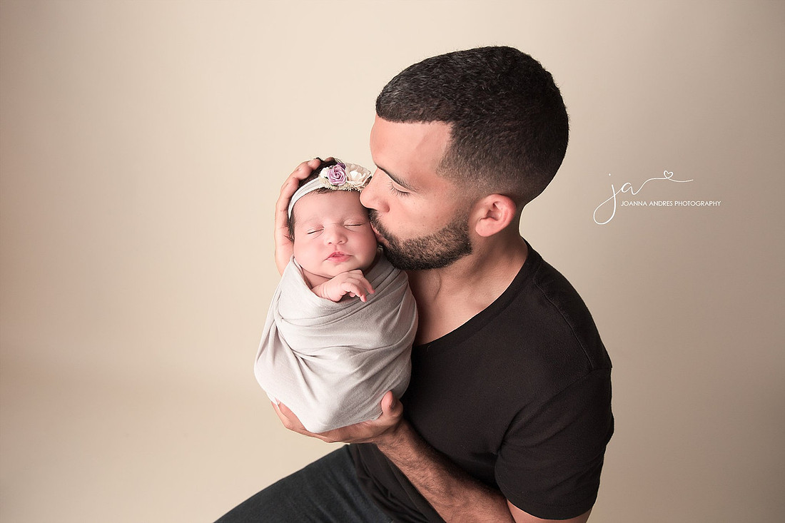 Dad Kissing Newborn Baby Girl