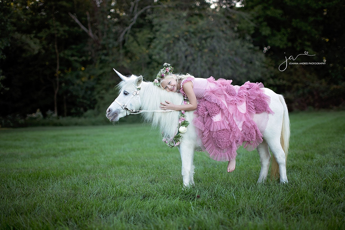 Girl Laying on Unicorn