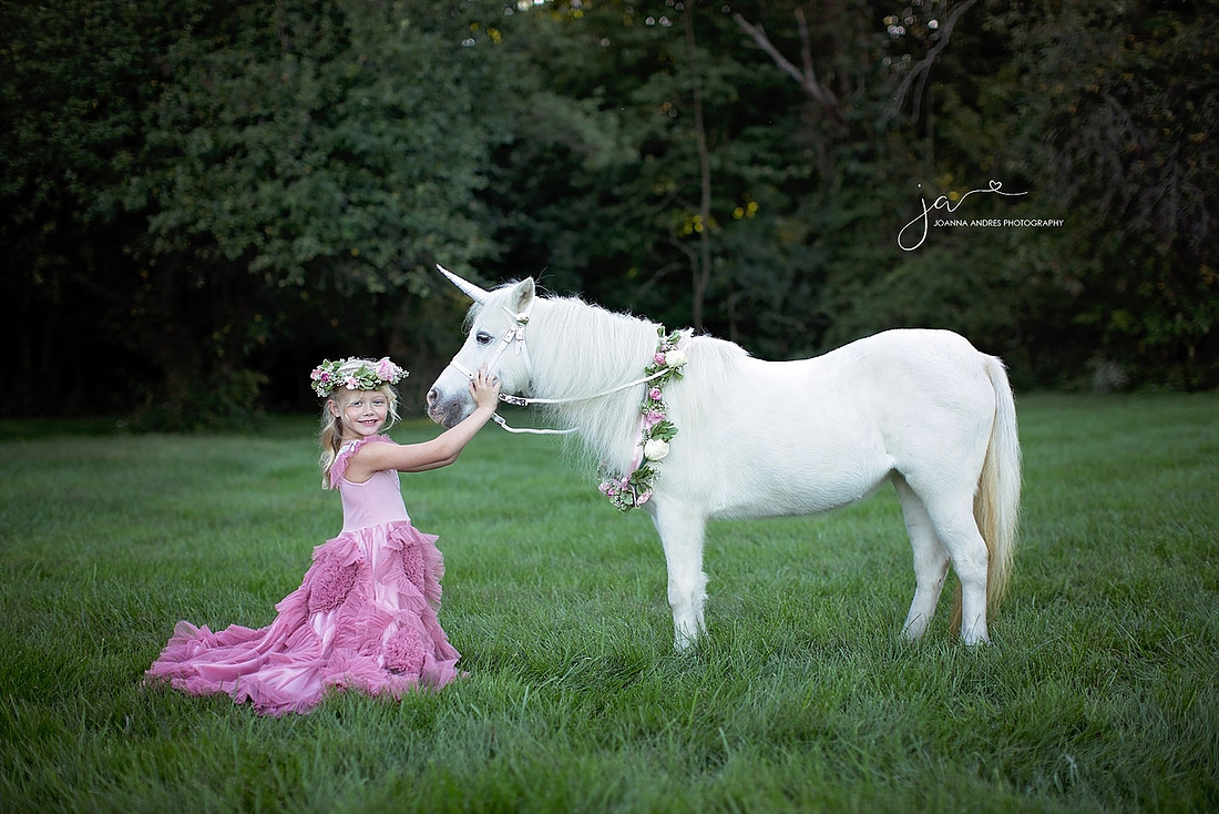 Girl Kneeling next to unicorn