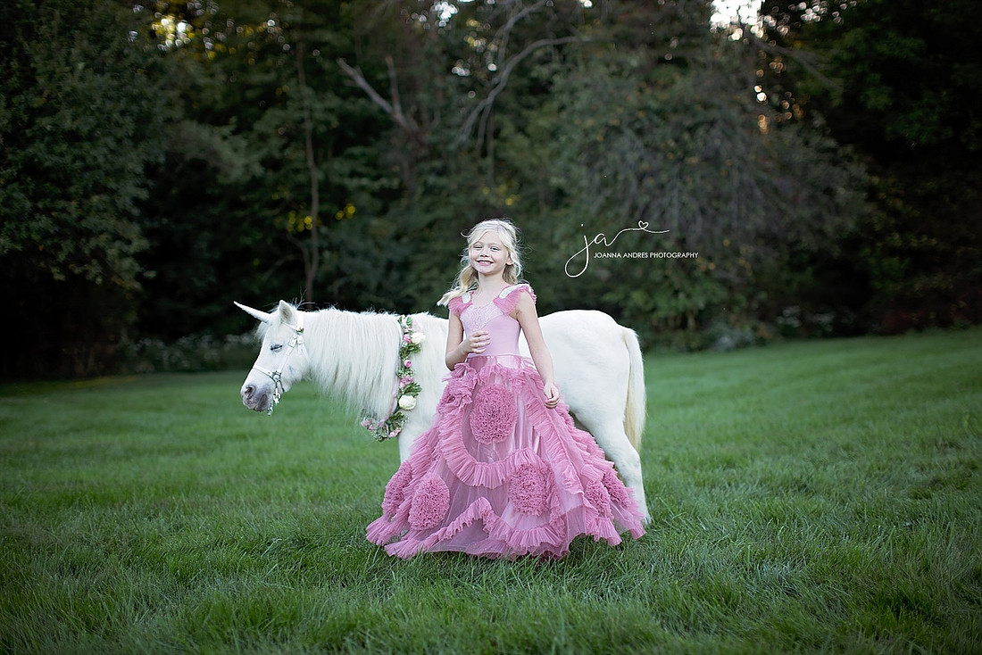 Unicorn with girl in a Boutique dress twirling