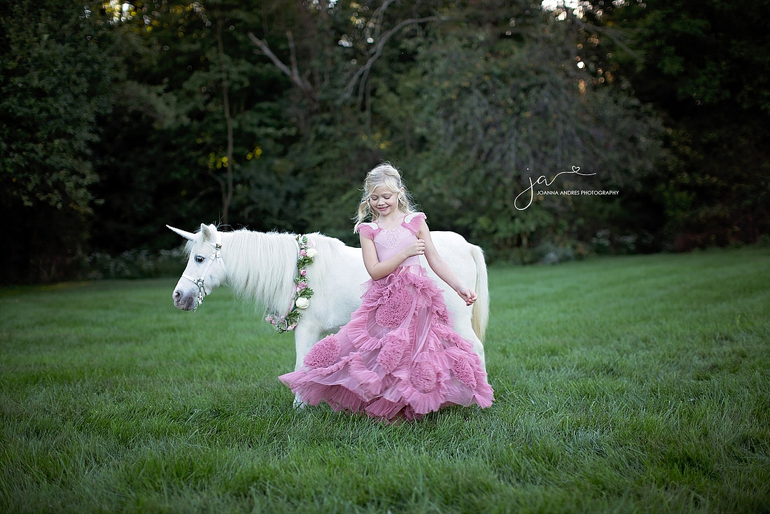Girl twirling in front of Unicorn