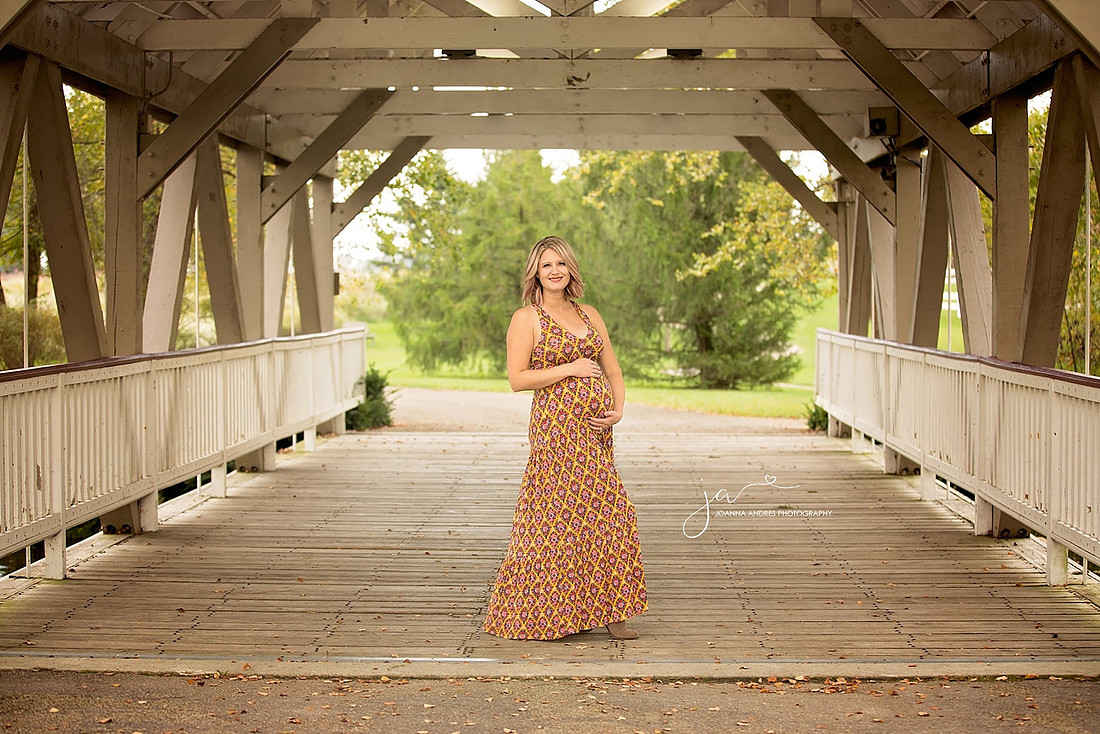 Maternity Photo of woman on a bridge with a fall dress