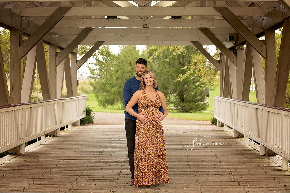 Materntiy Photo of Couple on Bridge