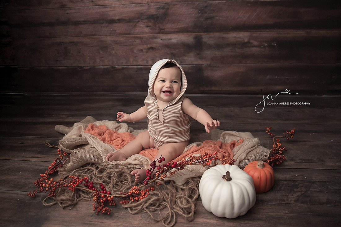 Baby Boy in Neutrals with a Fall Theme and pumpkins