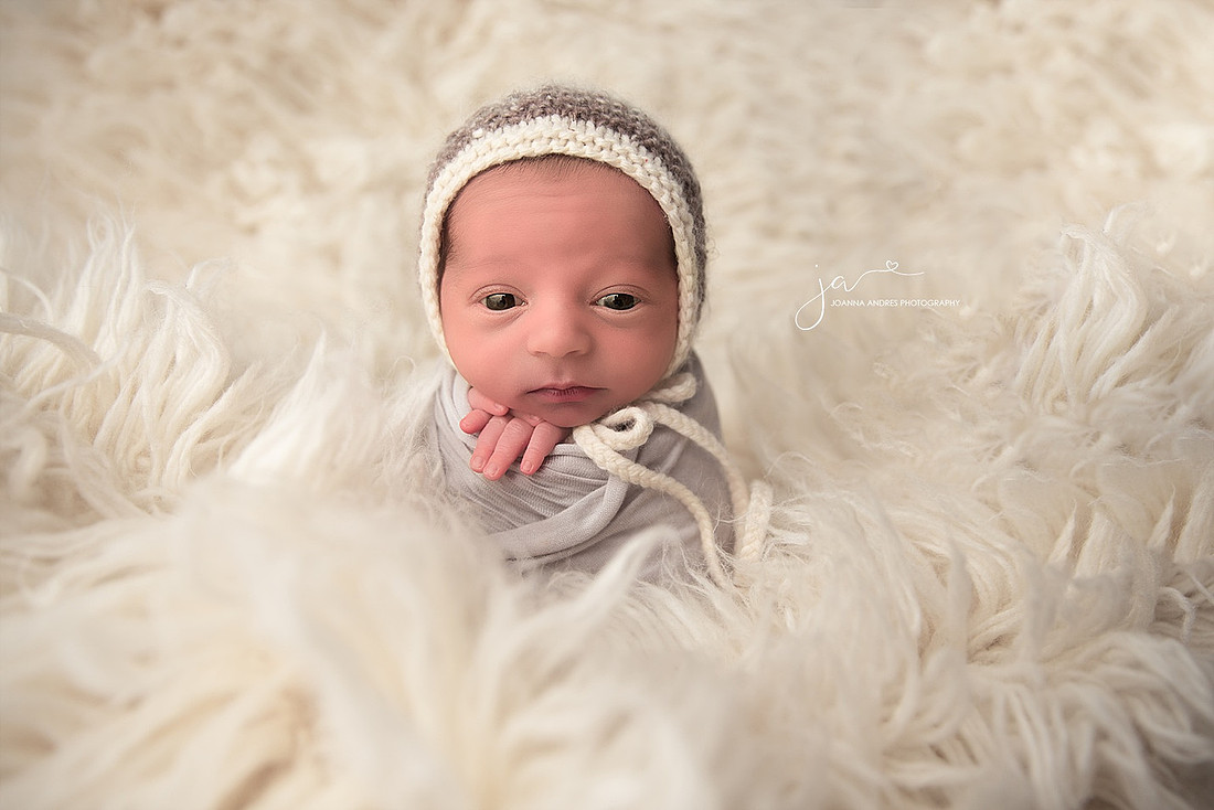 Baby Boy wrapped in Gray with white bonnet