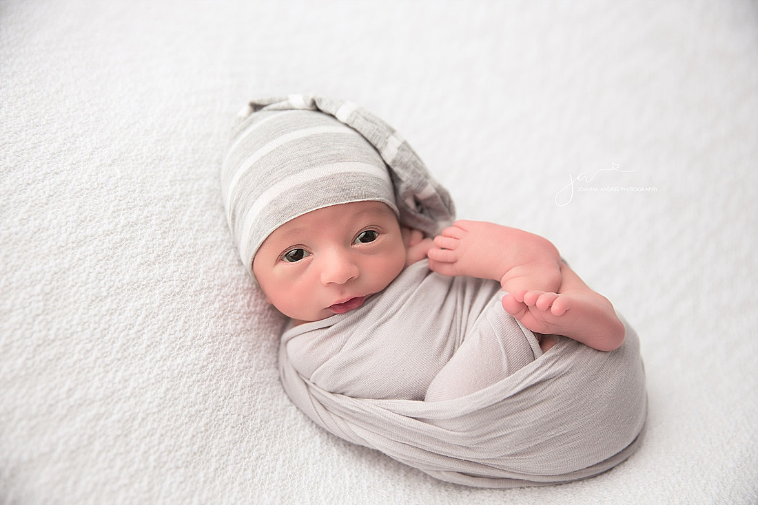 Baby Boy wrapped in grays with white backdrop